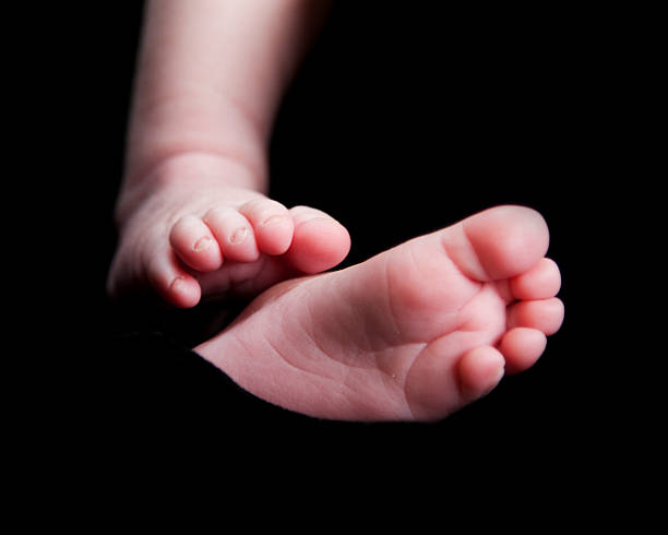 istock Tiny Feet of Newborn Baby 176831379