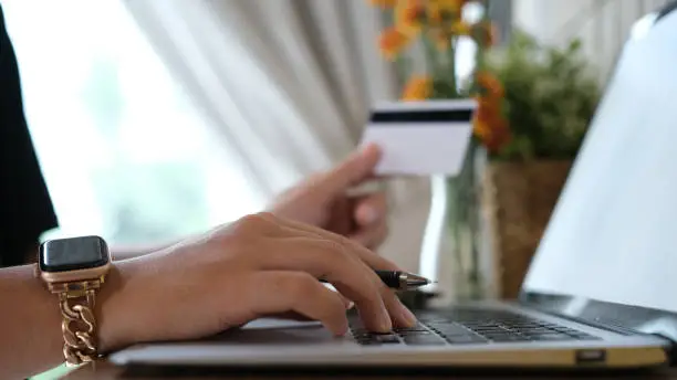 woman uses smart tablet computer and holds credit card with online shopping.Online payment concept.