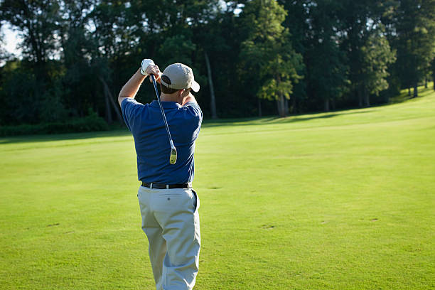 istock Golfer swinging club in late afternoon sunlight 176831761