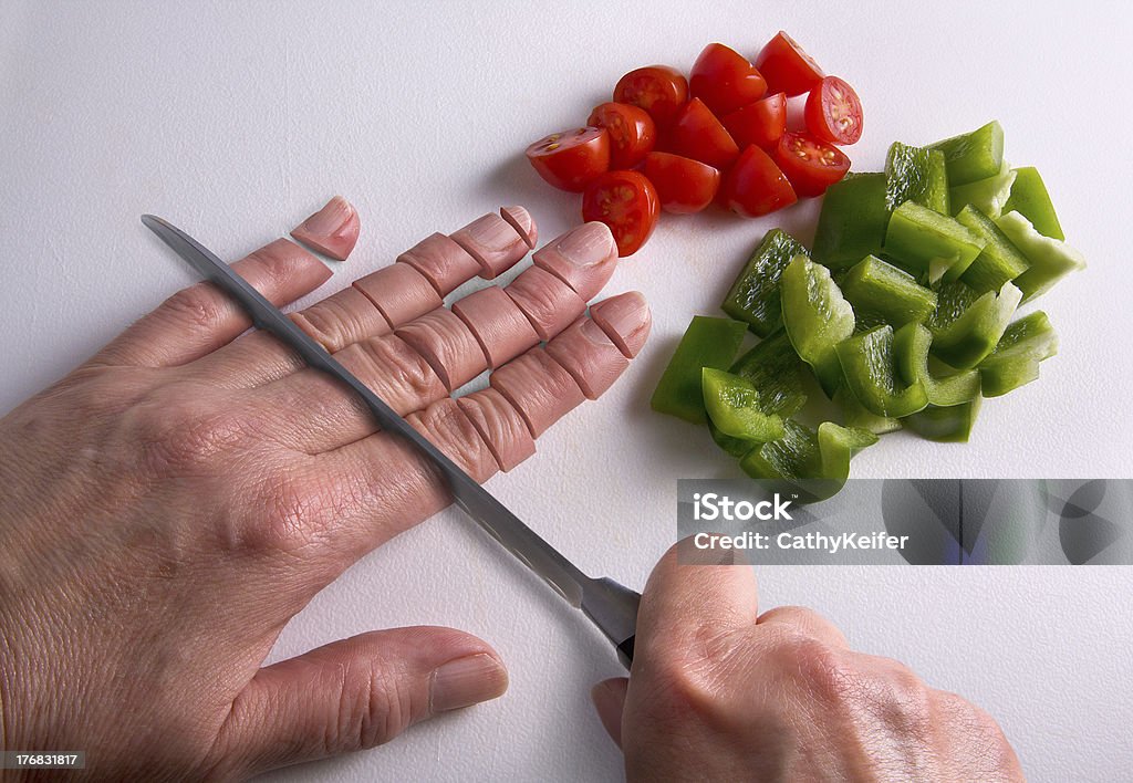 Chopping fingers on cutting board A human hand is being chopped with a knife on a cutting board. Cutting Stock Photo