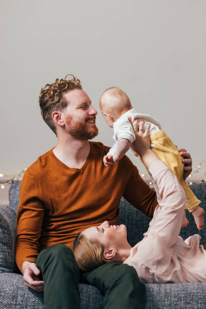istock Christmas in the Air: Dad's Relaxation, Mom's Joy, Baby's Laughter 1768323034