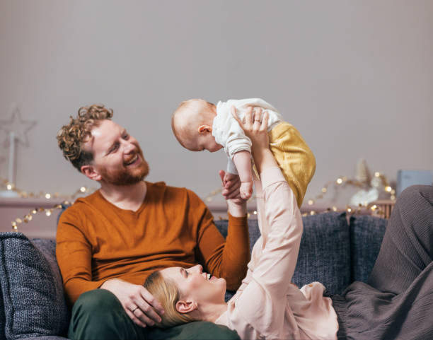 istock Christmas in the Air: Dad's Relaxation, Mom's Joy, Baby's Laughter 1768323047