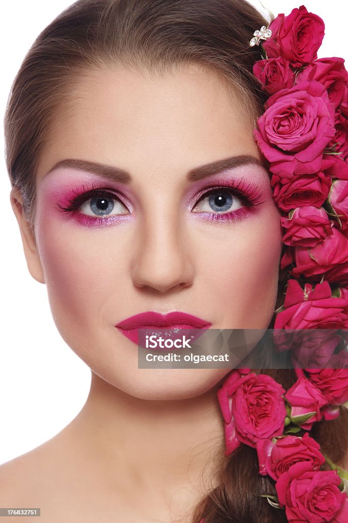 Beauty with roses Portrait of young beautiful woman with bright make-up and pink roses in hair Adult Stock Photo