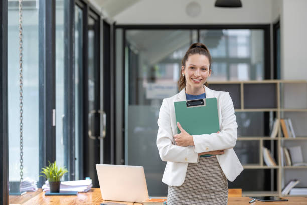 istock Businesswoman stands holding a document 1768334091