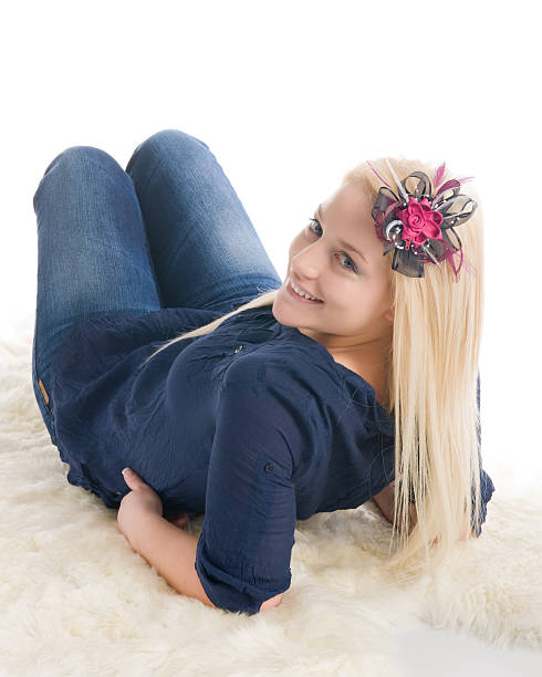 Beautiful blond girl on sheepskin stock photo