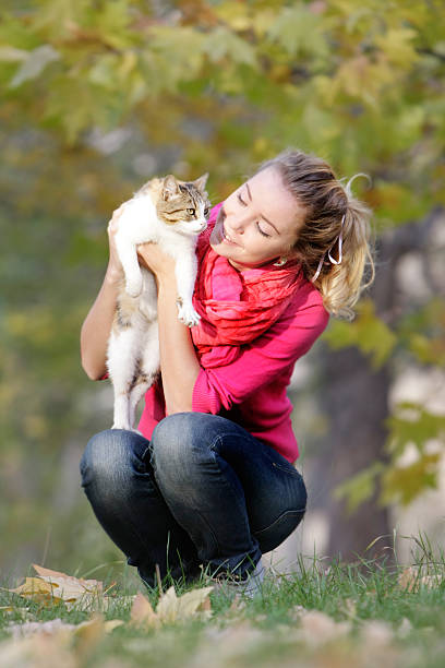 istock young girl with cat on natural background 176833706
