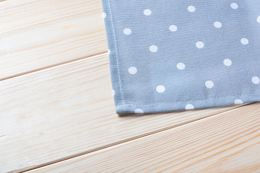 Gray Checkered napkin on wooden background.