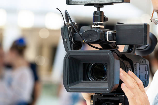 istock Professional video camera set. Front view of camcorder lens close up. 1768342426
