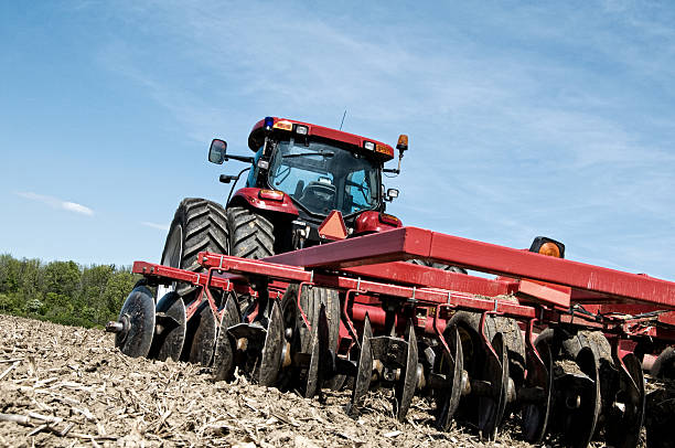 istock Idyllic Harvest Scene, Tractor and Plowed Field 176834379