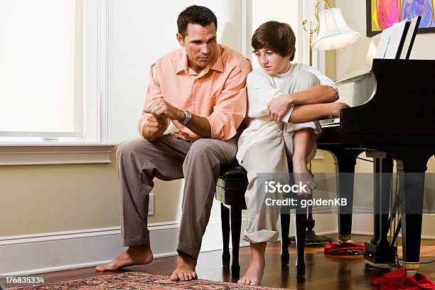 Serious Father Talking To Teenage Son At Home Stock Photo - Download Image Now - Discussion, Talking, Parent