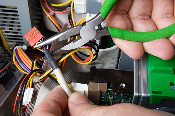 istock Electrician cutting wires with green pliers 176835688
