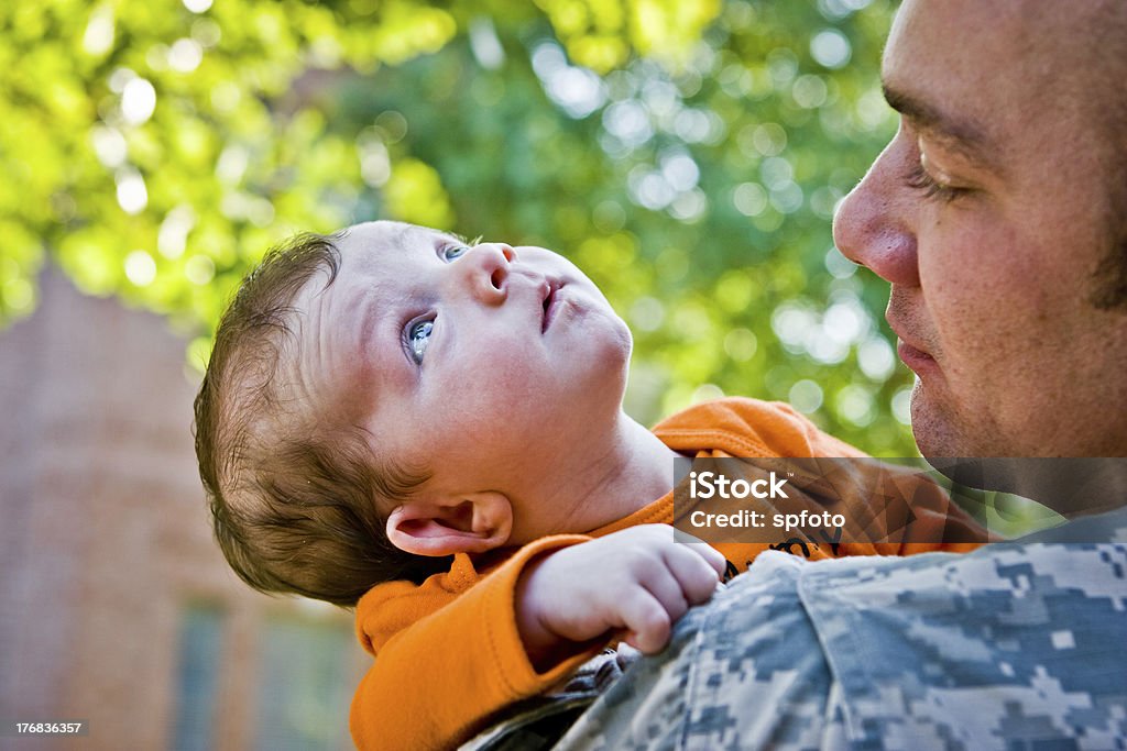Military Daddy Strong and tender an army man holding his new baby.More of them here - 0-11 Months Stock Photo