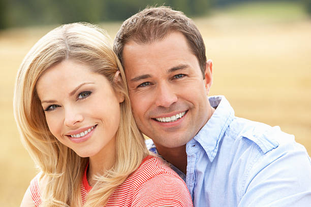 istock Couple Sitting In Field 176836679