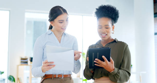 istock Business people, documents and tablet for teamwork, planning and marketing collaboration or advice in office. Professional women or manager on digital technology, social media report or happy results 1768370753