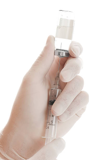 istock Syringe and vial in hands 176837869