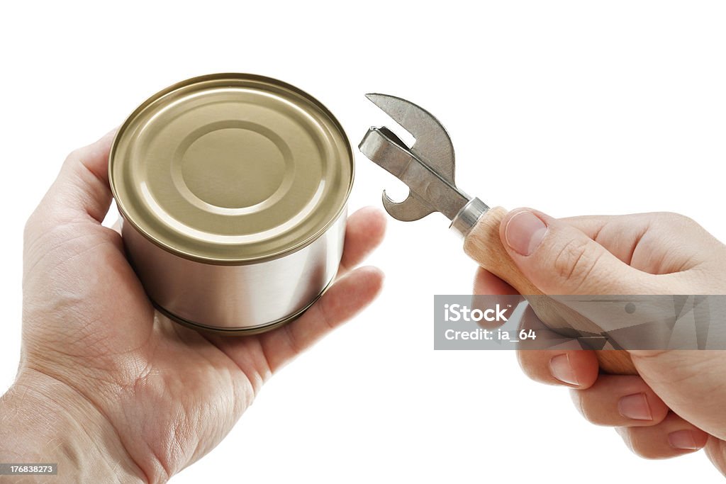 Canned food Hand holding canned preserved food metal can opener Aluminum Stock Photo