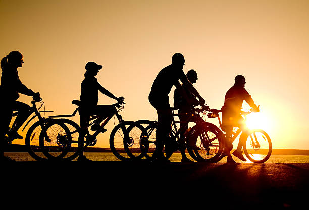 istock Friends riding bicycles at sunset 176838441