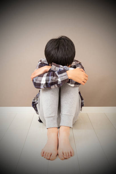istock A boy feeling depressed in his room. 1768387760