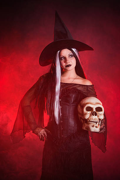 istock Halloween witch  skull over color background with smoke 176839185