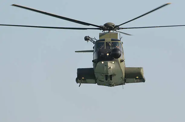 "HH-3F Italian Airforce rescue helicopter hovering.No corp insignas nor flags,marks,numbers are visible. Standard writings on fuselage related to security procedures and warnings."