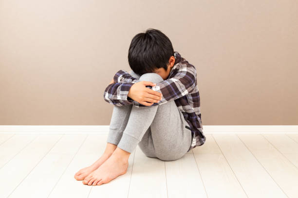 istock A boy feeling depressed in his room. 1768394970