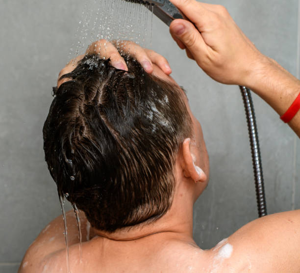 istock A man washes his hair in the shower 1768396505