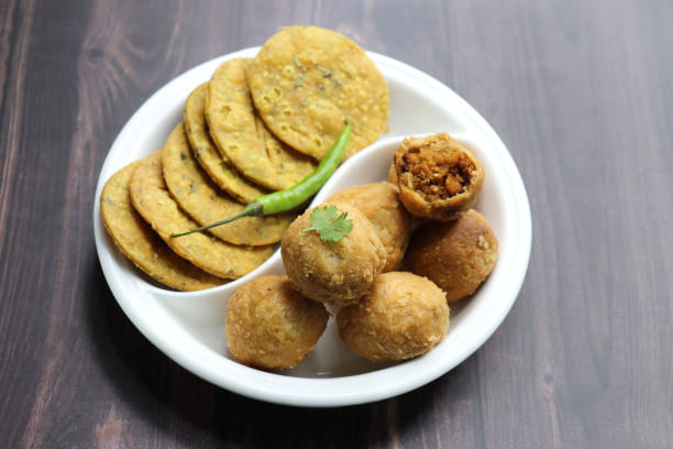 istock Indian popular snacks plate Dry Kachori and methi mathri. made using maida flour, a spicy mix of gram flour, sev, Lentils, Tamarind chutney and other Indian spices. A popular tea time snack. 1768400248