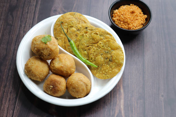 istock Indian popular snacks plate Dry Kachori and methi mathri. made using maida flour, a spicy mix of gram flour, sev, Lentils, Tamarind chutney and other Indian spices. A popular tea time snack. 1768400273