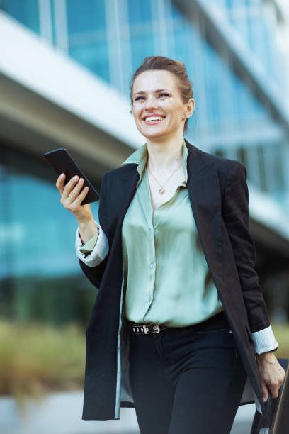 istock smiling modern woman worker in business district walking 1768405139