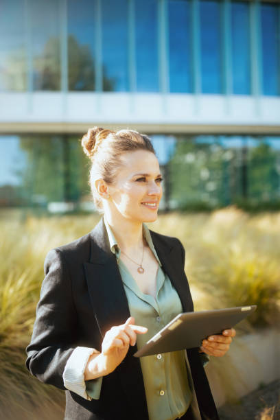 istock happy woman worker in business district using tablet PC 1768405659