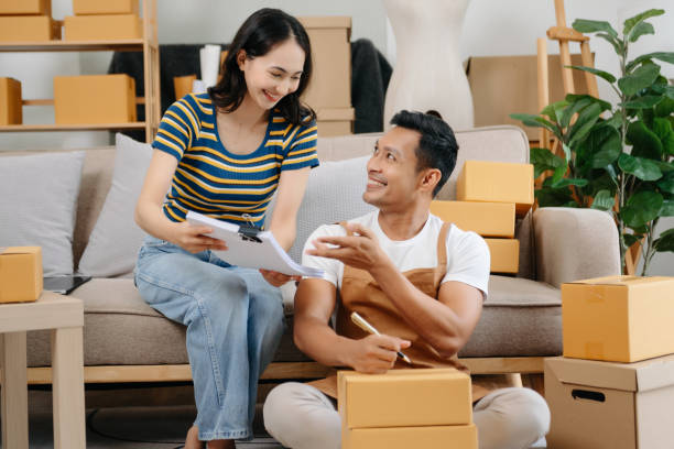 istock Starting small businesses SME owners, two check online orders Selling products working with boxs freelance work at office using tablet and laptop  marketing, packaging, concept 1768407815