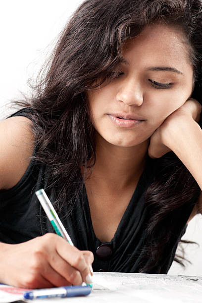 istock Tense beautiful indian girl writing on paper 176840854