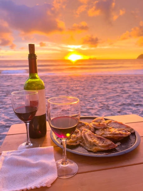 istock Picnic table set at sunset on the beach 1768408883