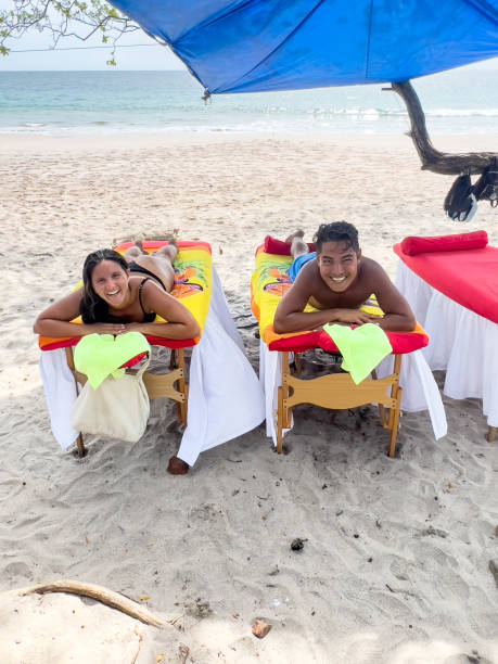istock Couple having a massage on the beach 1768409525