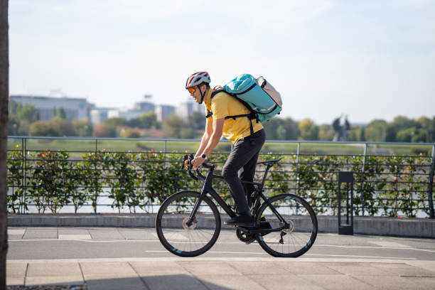 istock Courier on bicycle delivering food 1768414383