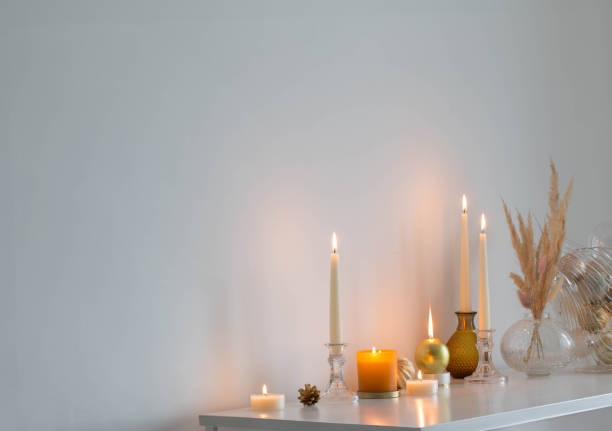 istock christmas decorations with burning candles in white room 1768415905