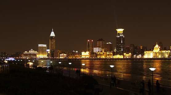 city view at night showing the Bund, an area of the Huangpu District in Shanghai which is a city in China