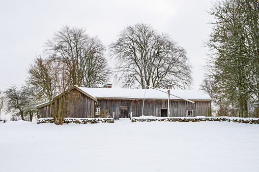 Old farmhouse on a hill in winter