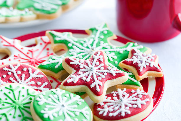 Red and green iced Christmas biscuits Colorful Christmas cookies on a plate christmas cookies stock pictures, royalty-free photos & images