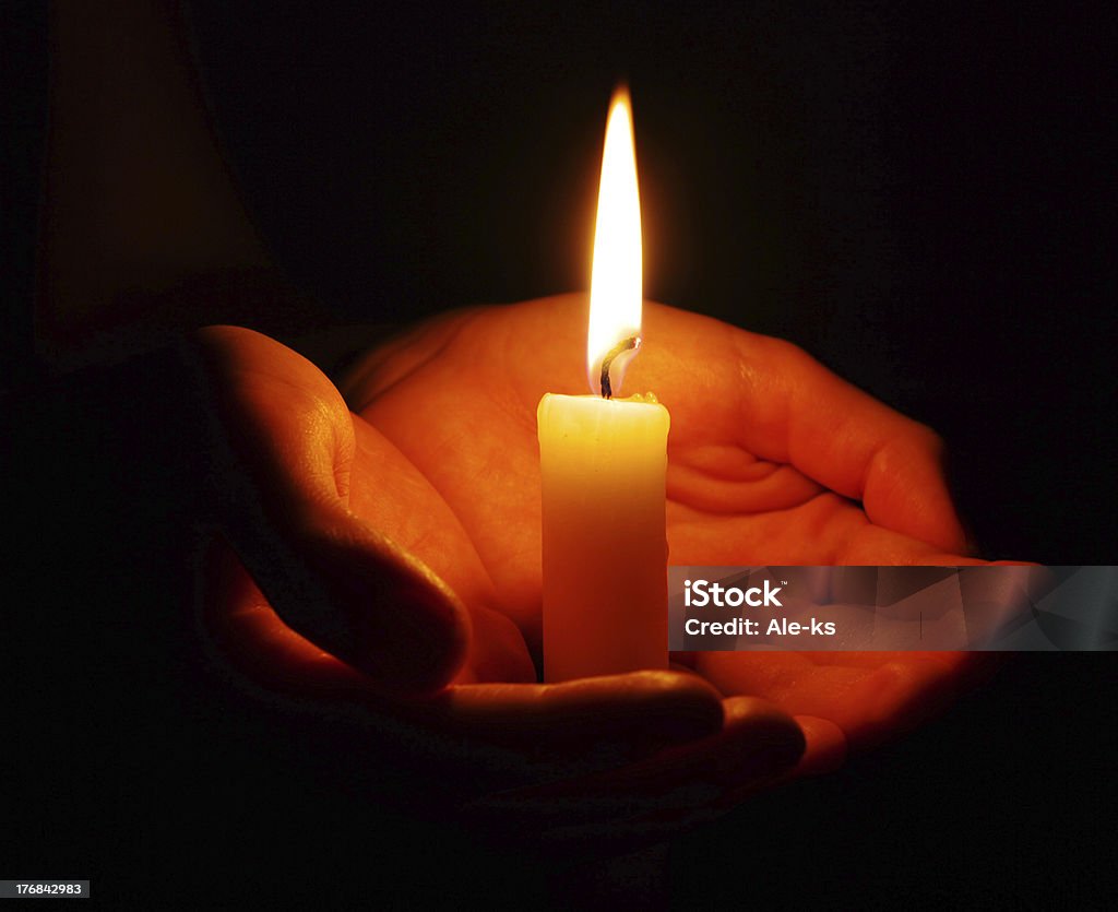 burning candle burning candle isolated on black background. Burning Stock Photo