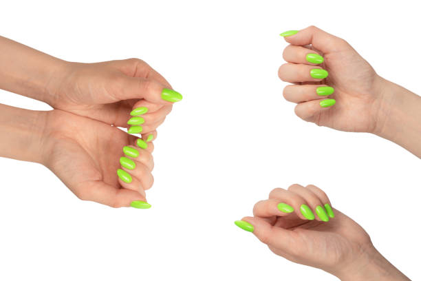 istock Hand of a woman with green naols hold some tiny or thin object. 1768430379
