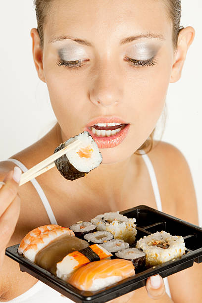 istock woman with sushi 176843112