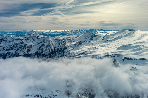 Aerial view of a snowy winter landscape and perfect conditions in ski resort in the morning. Panorama photographed in Brandnertal, Vorarlberg, Austria.