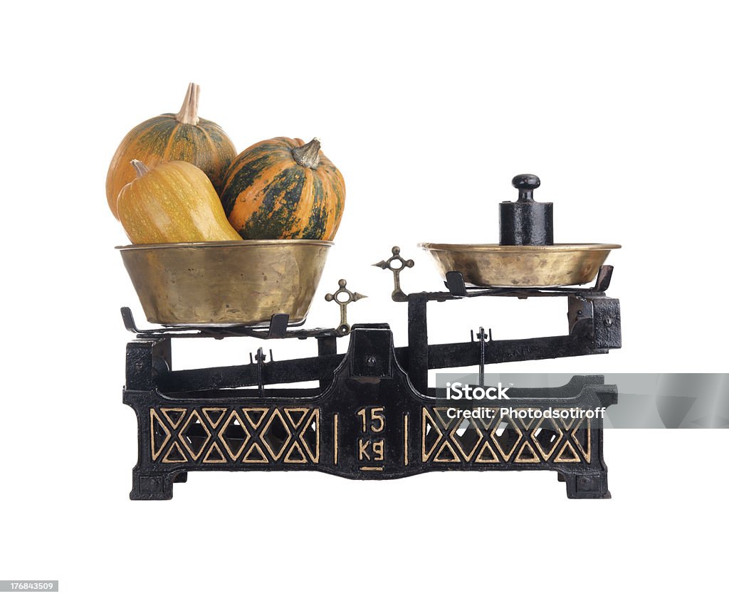 Old-fashioned balance scale with pumpkins Old-fashioned balance scale with pumpkins isolated on white background Accuracy Stock Photo