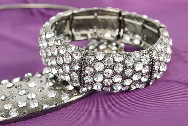 istock Silver necklace and bracelet  on the purple. 176843532