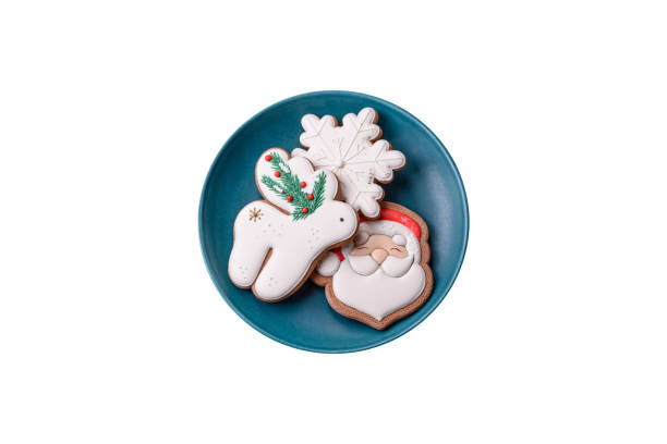 Beautiful Christmas gingerbread cookies on a round ceramic plate on a textured concrete background