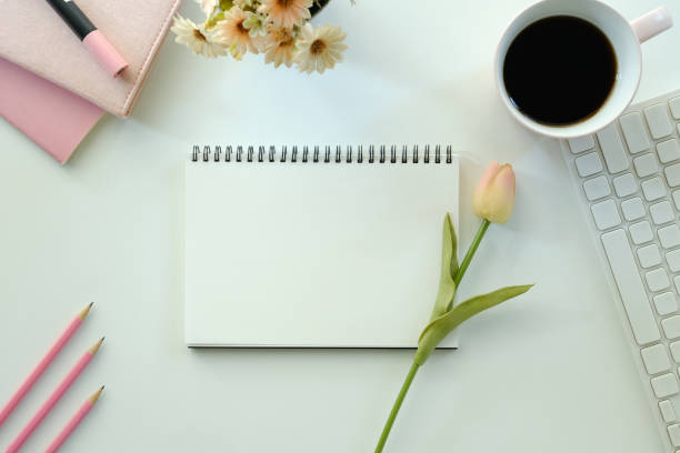 istock White office desk table with blank notebook, computer keyboard and other office supplies. Top view with copy space, flat lay. 1768444826