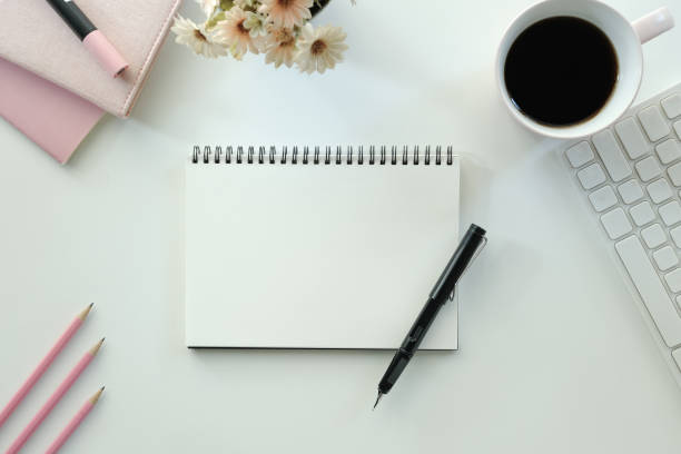 istock White office desk table with blank notebook, computer keyboard and other office supplies. Top view with copy space, flat lay. 1768445388