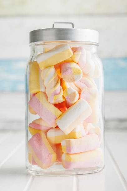 istock Sweet colorful marshmallows in jar on white kitchen table. 1768446454