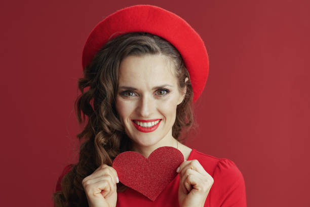 istock smiling stylish female isolated on red background 1768448537